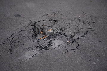 Damaged road. Deep crack on the asphalt.