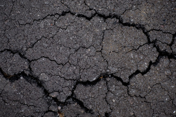 Damaged road. Deep crack on the asphalt.