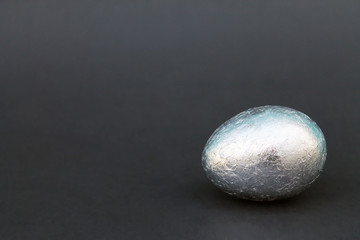 Easter Gold and silver egg on black background