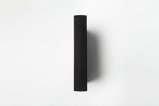 Vertically Standing Blank Black Book Mock Up On A White Background.High Resolution Photo.