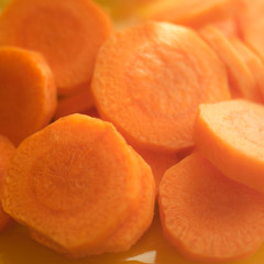 Raw round slices of carrots close up.