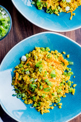 Cauliflower rice is a low calorie healthy substitute for grains of actual rice. Cauliflower rice seasoned with a mix of spices and tossed with olive oil lemon juice and garnished with scallions.