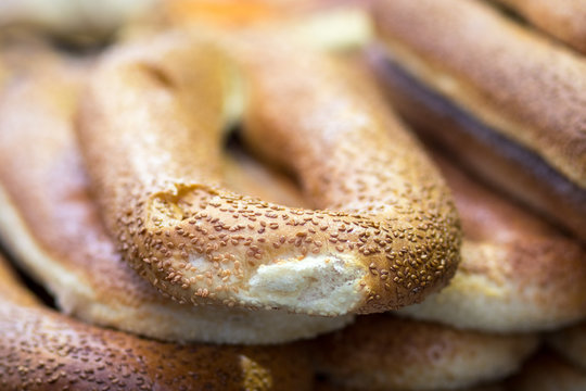 Pretzels, Arabian bread, coated with sesame seeds. Arranged in stack on top of each other, on a blurred background. The Mahane Yehuda Market, Jerusalem.