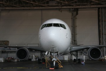Fototapeta premium Photo taken from the front of an airplane in a maintenance shop