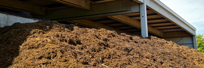 Compost and composted soil as a composting pile. composted soil pile at the compost plant. turning...