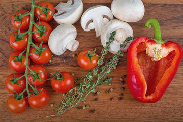 ripe tomatoes and other ingredients on dark baclkground