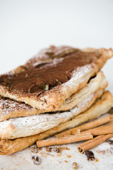 Crunchy puff pastry pie. Homemade baked pie with pears. Top view. Delicious dessert with sliced pear and chocolate powder.