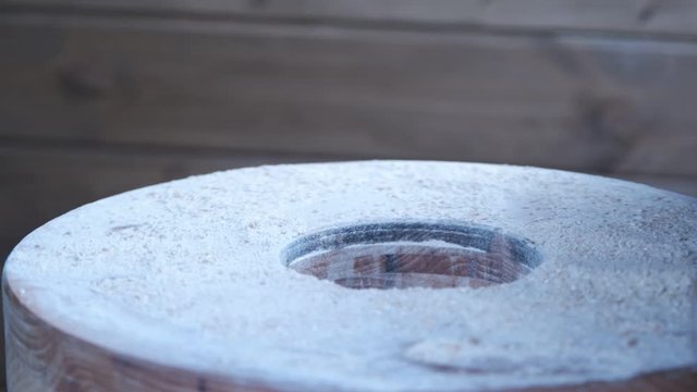 Manual mill for grinding wheat. Making flour. Millstones are twisted by children, studying the work of the mill in the fablab.