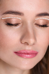 Beautiful girl with pearls make-up, pink lips.