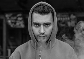 a man smoking hookah at cafe and relaxing