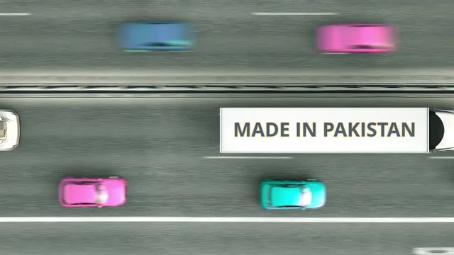 Aerial top down view of semi-trailer trucks with MADE IN PAKISTAN text driving along the road. Pakistani business related loopable 3D animation