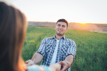 Fototapeta premium Guy with a girl spinning holding hands