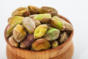 Pistachio nuts. Many pistachios on white.  Selective focus