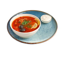 Traditional georgian hot tasty soup kharcho decorated with parsley. Isolated on white.