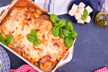 Healthy zucchini lasagna bolognese in a baking dish.Oven baked traditional Italian cuisine with mozzarella, parmesan, basil and vegetables. Copy space. Above