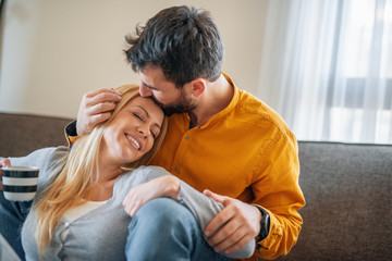 Couple relax at home with cup of coffee