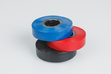 Adhesive insulating tapes or plastic duct tape rolls, gray background