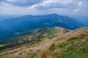 Conquering the mountain peaks. Hike on the mountain hedges of the Carpathian Mountains