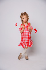 Funny smiling baby girl summer dress  on white background . Baby girl with a lip accessory on a stick.