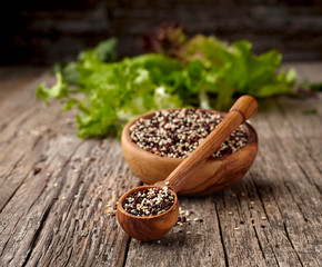 Quinoa with Green salad  on wooden background