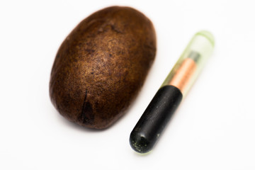 close-up photo of a coffee bean and a microchip for pets