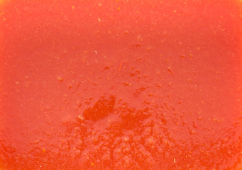 The texture of the tomato juice with the pulp in a rectangular shape. Red is a warm tone with a barely orange tinge.