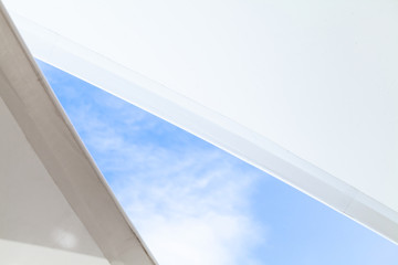 White sail shaped awnings are under bright blue sky