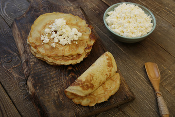 tasty pancakes with cottage cheese on wooden rustic background
