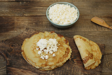 tasty pancakes with cottage cheese on wooden rustic background