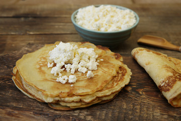 homemade pancakes with cottage cheese on a wooden rustic board