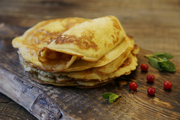 delicious pancakes on a wooden rustic board close-up