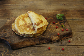 delicious homemade pancakes on a wooden rustic board