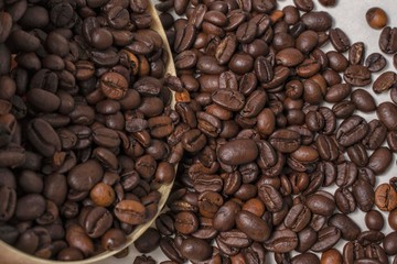 coffee beans spill out of a wooden container close-up