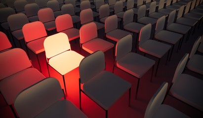 Obraz premium Concept or conceptual orange armchair standing out in a conference room as a metaphor for leadership, vision and strategy. A 3d illustration of individuality, creativity and achievement