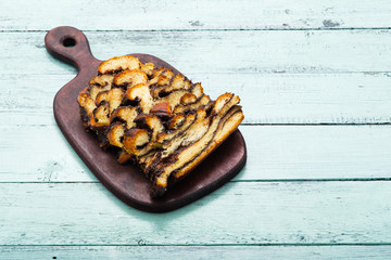 sliced babka, choclate challah dessert on old blue wooden table
