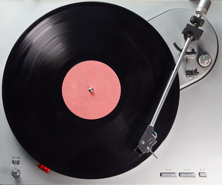 Vintage record player. Vinyl turntable of color metallic. Retro audio equipment for vinyl disk.