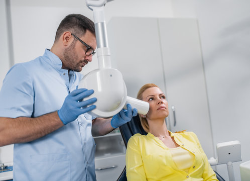 Dentist prepare to make tooth x-ray image for patient in dental clinic
