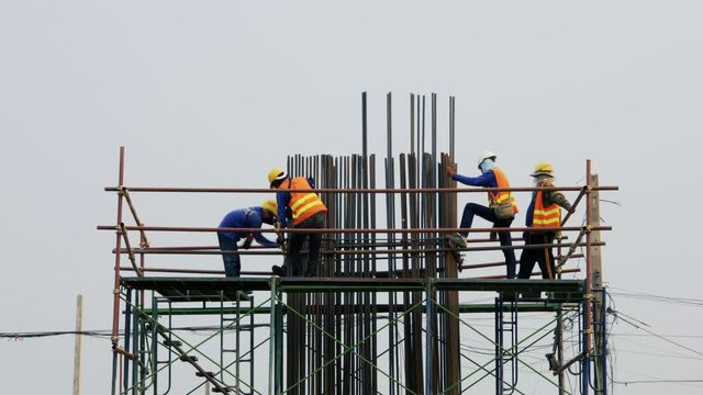 construction worker working on scaffolding in industrial construction Time Lapse 