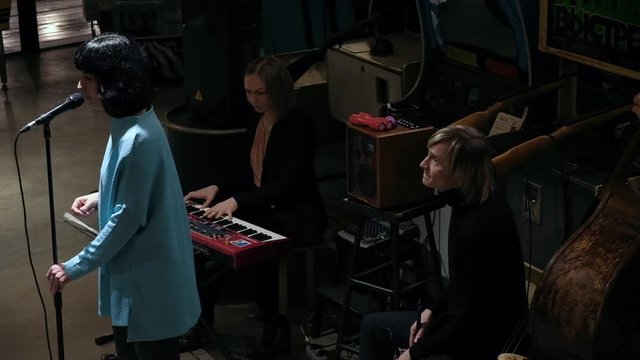 Long shot of jazz players performing live music at the cozy LOFT place