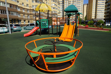  Children's little carousel in the playground.