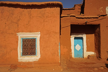 Detail of traditional Berber clay made house with blue doors and flat roof, Morocco