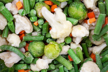 Different frozen vegetables as background, top view
