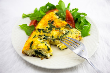 Frittata made of eggs, bacon, cheese and spinach