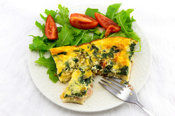 Frittata made of eggs, bacon, cheese and spinach
