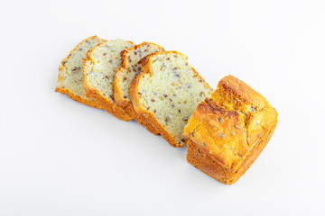 Sliced loaf of whole-grain bread on white background. Freshly baked homemade square bread. Organic and vegetarian food concept. Copy space for text, close up