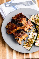 Pork BBQ Ribs. Tradtional Classic barbecue staple. Pork ribs seasoned with a dry rub and slow cooked in a smoker over mesquite wood chips and covered in bbq sauce. 