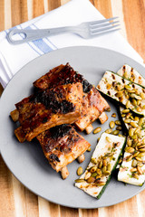 Pork BBQ Ribs. Tradtional Classic barbecue staple. Pork ribs seasoned with a dry rub and slow cooked in a smoker over mesquite wood chips and covered in bbq sauce. 