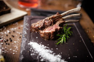 Grilled lamb chops served with a branch of rosemary