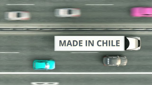 Aerial overhead view of semi-trailer trucks with MADE IN CHILE text driving along the highway. Chilean business related loopable 3D animation