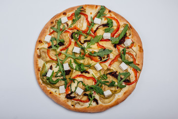Pizza with feta arugula pepper and leafy tomatoes. Vegetarian pizza. Vegan pizza